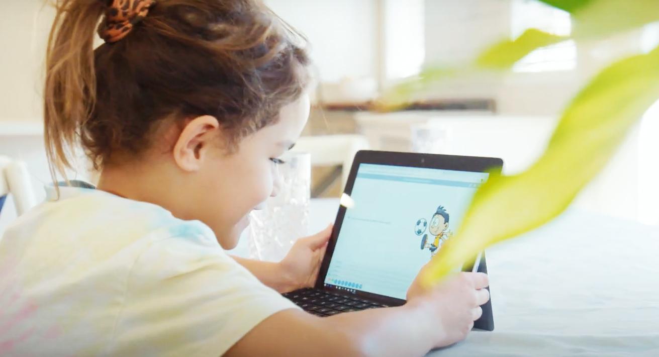 A young girl is using a tablet computer