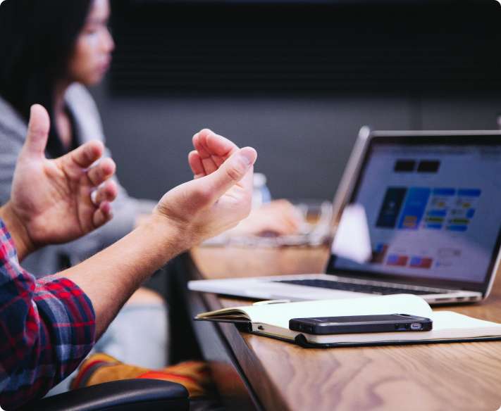 A person pointing at a laptop