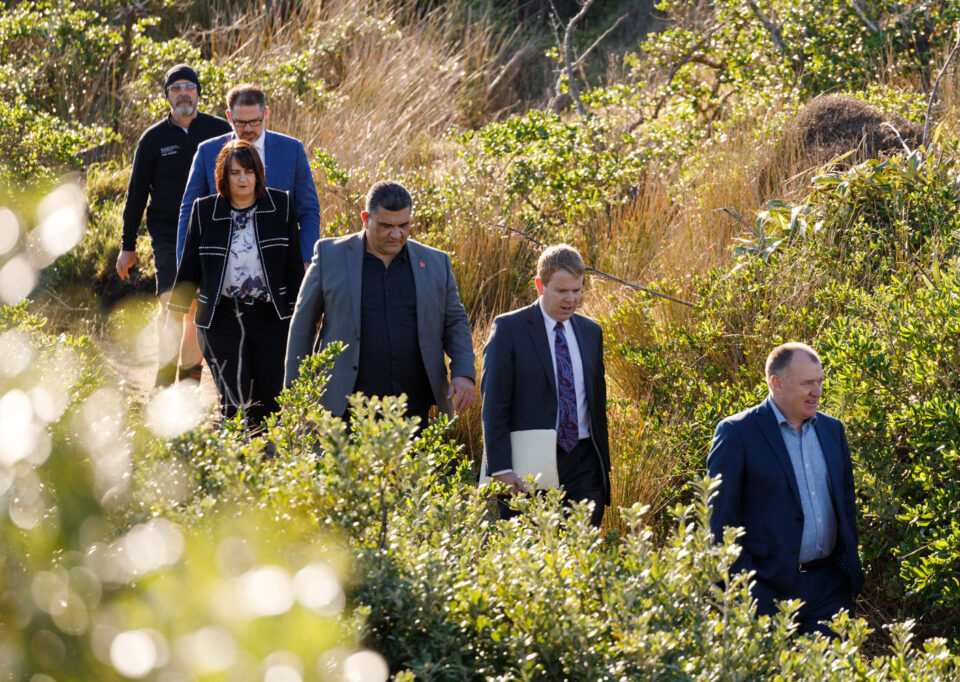 Group of people with then Minister of Education Chris Hipkins walking through the bush
