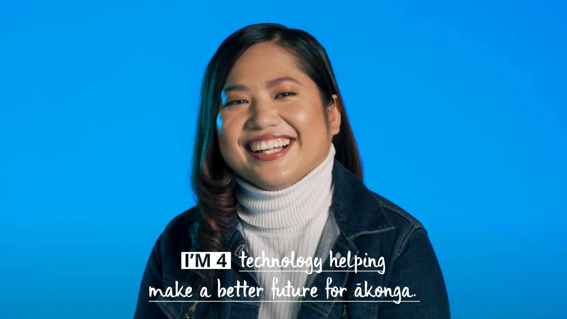 Woman smiling sitting in front of a blue background with caption: I'm for technology helping making a better future for akonga