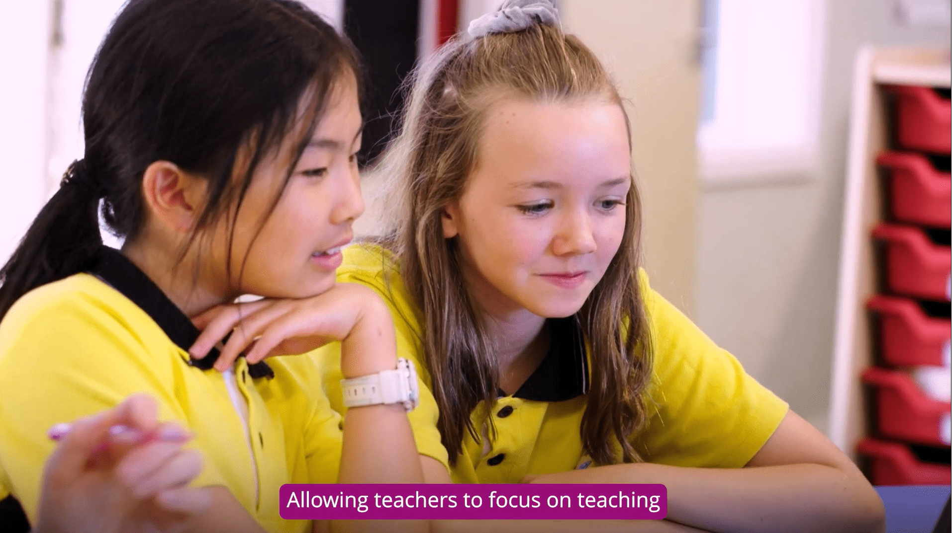 Two students learning on a laptop at school